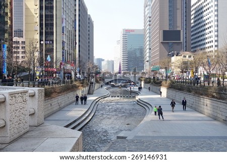 SEOUL, SOUTH KOREA - MARCH 25, 2015: People at Cheonggyecheon stream. The stream is a 10.9 km (7.0 miles) long, modern public recreation space in downtown Seoul, South Korea.
