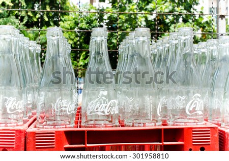 BANGKOK â?? JULY 28: Empty recycle bottles of Coca Cola in red plastic box on July 28, 2015 in Bangkok, Thailand. Coca Cola drinks are produced and manufactured by The Coca-Cola Company
