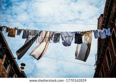 Similar – Image, Stock Photo Towels on clothesline between two trees on the campsite. In the background a caravan with awning.
