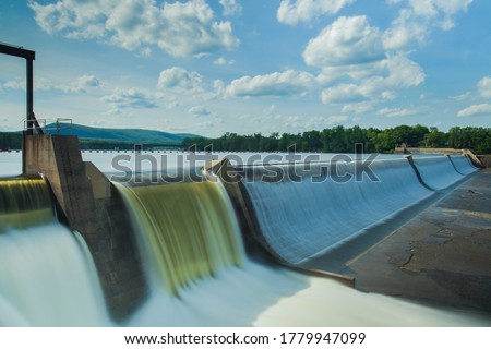 Hydroelectric power energy plant with turbines and water spills for generating green electricity. Free, green adn ecological energy concept. Climate changes