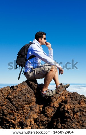 Young Man Having a Rest in a High Peak Over Clouds in Teide Mountain, Spain