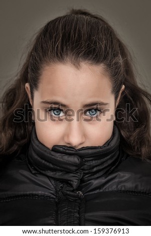 Serious Girl with Her Mouth Covered