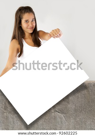 Teenager girl holding a blank banner