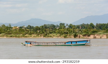Shipping Lao boat carry goods from border of Myanmar and Lao on The Mae khong river in Chiangsaen ,Chiangrai Thailand