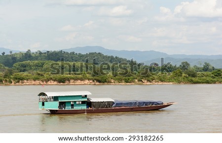 Shipping Lao boat carry goods from border of Myanmar and Lao on  The Mae khong river in Chiangsaen ,Chiangrai Thailand