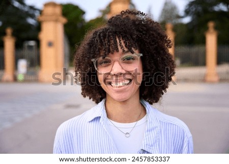 Similar – Image, Stock Photo Close up portrait of young arab woman looking away from camera white shirt and blue jeans smiling to camera on a block in the hood. Street life style, cool trendy. Social network concept