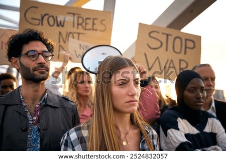 Similar – Image, Stock Photo Peace demonstration against the war of aggression against Ukraine started by Putin. Demonstrator in the national colors of Ukraine holding up a sign. Rear view