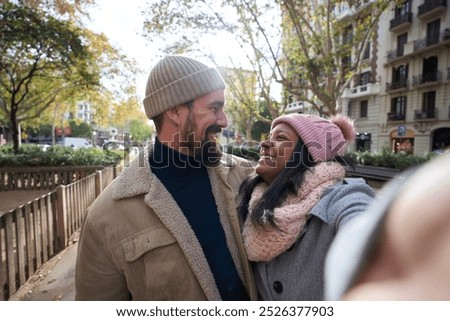 Similar – Image, Stock Photo Cheerful ethnic couple taking selfie in park