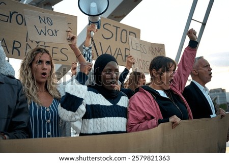 Similar – Image, Stock Photo Peace demonstration against the war of aggression against Ukraine started by Putin. Demonstrator in the national colors of Ukraine holding up a sign. Rear view