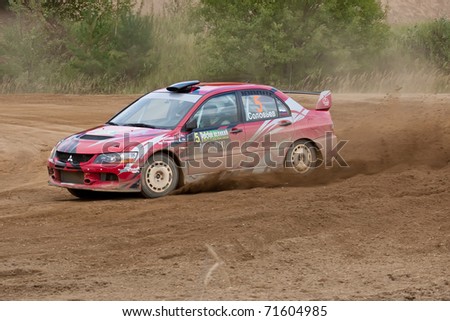 ROSTOV, RUSSIA - SEPTEMBER 05: Alex Federov drives a red Mitsubishi Lancer car during the Rostov Velikiy Russian rally championship on September 05, 2010 in Rostov, Russia.