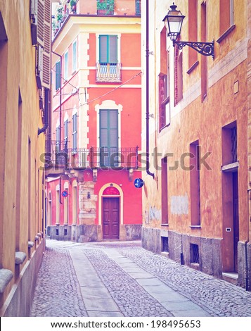 Narrow Alley with Old Buildings in the Italian City of Cuneo, Retro Effect