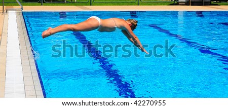 Woman Diving Into Blue Waters In Competition