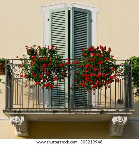 Renovated Facade of the Old Italian House with Balcony Decorated with Fresh Flowers, Instagram Effect