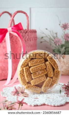 Kaasstengels cheese sticks, or commonly known as kastengel is Dutch-Indonesian Cheese Cookies. Very popular for Eid al Fitr and other special moment. Beautiful pink decoration. Stok fotoğraf © 