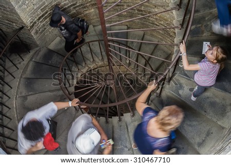 SAINT PETERSBURG, RUSSIA - AUGUST 11, 2015: Tourists climb the stone spiral staircase to the colonnade of St. Isaac\'s Cathedral (1819-1858). It is the largest Russian Orthodox cathedral in the city.