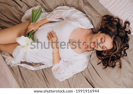 Beautiful pregnant woman in white clothes. View from above. Health care. Imagine de stoc © 