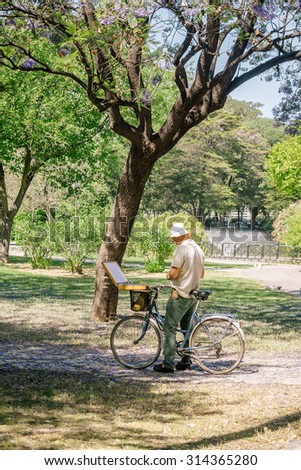 19, 2015: SEVILLA, SPAIN - FEBRUARY 12, 2015: Mature man painting on canvas in a park. May spring in the beautiful city of Seville
