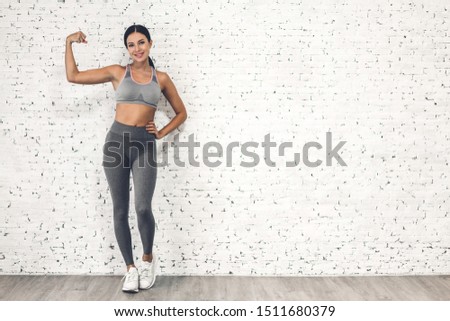 Similar – Image, Stock Photo Fit woman standing against sea during workout