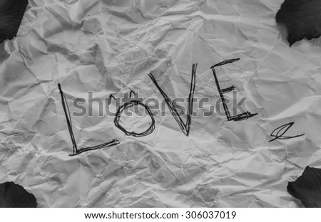 Crumpled paper sheet with word Love  -black and white tone