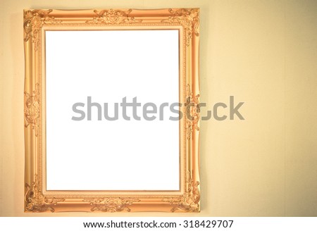 Gold picture frame on wall background - vintage tone
