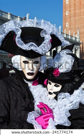 Venice, Italy - February 2010: A couple wearing traditional masked clothing in the days of carnival