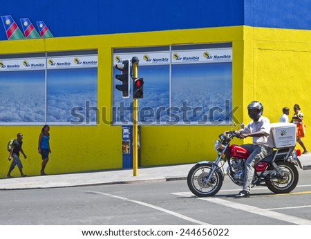 Windhoek, Namibia - December 14 2009: A man on a motorbike and other local people in an intersection of the city center