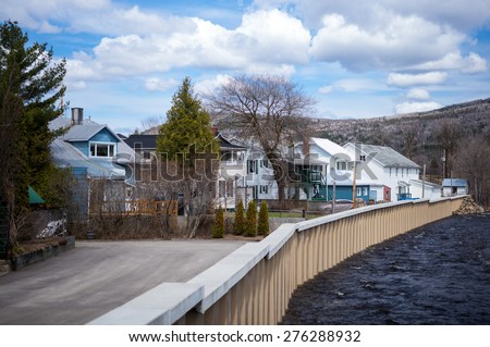 Baie Saint Paul, Canada - May 6 2014: Houses on the river in the town outskirts