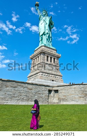 New York, U.S.A. - July 12 2009: Liberty Island, a woman in traditional dress near the basement of the Liberty Statue