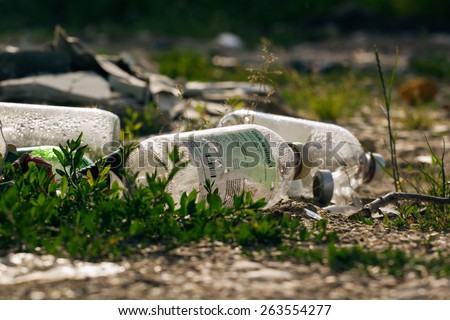 ZAGREB, CROATIA - JUNE 27, 2013: Medical waste, bottles of glucosaline solution discarded in nature.