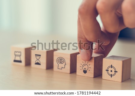 business man hand arranging wood block . icon of business strategy including element with goal, idea, leadership, management of time, Knowledge, Initiative, Human relations with copy space