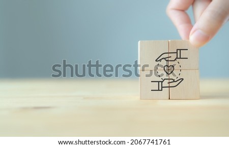 Customer relationship management (CRM) or customer loyalty concept. Customer satisfaction, retention strategies. CRM or customer loyalty program banner. Hand put wooden cubes with holding heart icon. Сток-фото © 