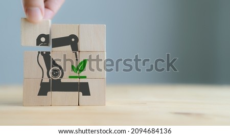 Industrial ecosystems, green industry concept. Business target to net zero. Banner of ecology and environment concept. Hand puts wooden cubes with green industry icon on grey background and copy space 商業照片 © 