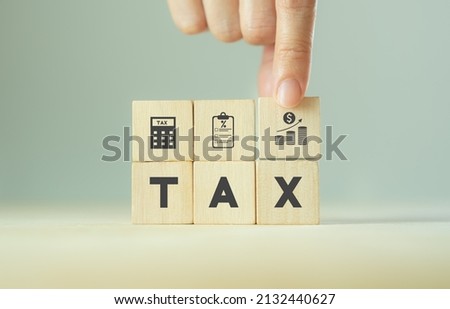 TAX concept, on wooden block  including of State taxes,Tax payment, Governant ,calculating finance, tax accounting, statistics and data analytic reserach, calculation tax return, strategy plan, report ストックフォト © 