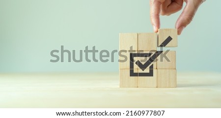 Corporate regulatory and compliance. Goals achievement and business success. Task completion. Ethical corporate. Do the right thing. Quality and ISO symbol. Placing wooden cube with checkmark icon.. Foto stock © 