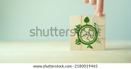 Eco friendly, green company culture concept. Carbon neutral and net zero target. Sustainable enviroment and business limit global warming. Build green community. Wooden cubes with eco globe icon. 商業照片 © 