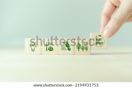 Net zero action concept. Save energy, green energy, reduce carbon footprint, carbon capture. Climate neutral long term strategy. Limit  global warming. Putting wooden cubes with green net zero icon 商業照片 © 