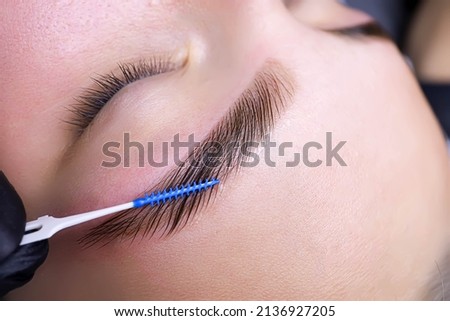 combing the hairs in the eyebrows with a brush after the procedure of coloring and laminating the eyebrows Stockfoto © 