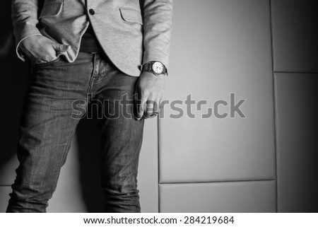 Black and White Color Businessman in gray suite,jeans. Part of body. On beige color background