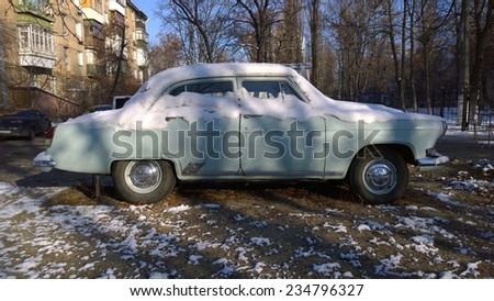 Old car covered with snow - Old soviet car - Vintage auto