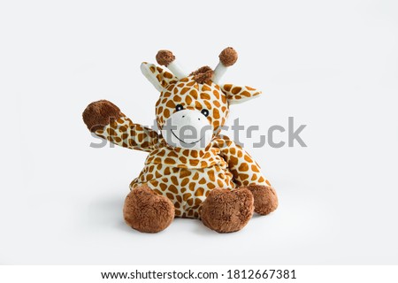 Giraffe plush toy isolated on white background with shadow reflection. Giraffe plush doll on white background. Colorful plush toy. Colored stuffed toy-giraffe. White brown giraffe