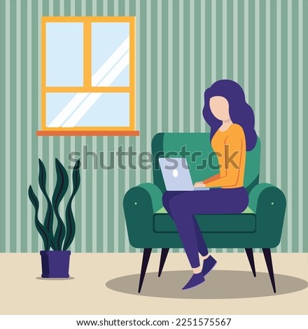 Woman working at home using laptop sitting on couch. scene of person working from home.