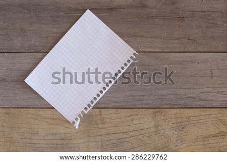 sheet of grid paper over a wooden surface