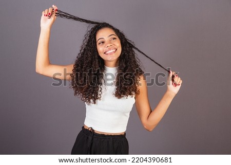 Young brazilian black woman, fiddling with hair, curls, curly, afro hair. pulling hair Foto stock © 