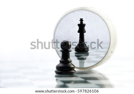 pawn pieces on the chessboard, the reflection in the mirror king, often in life things and people are not what they seem 商業照片 © 