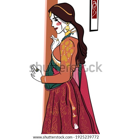 An traditional Indian bride is standing and touching wall, hanging photo frame, bridal getup 