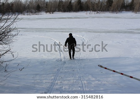 Guy walks outdoors in the cold winter