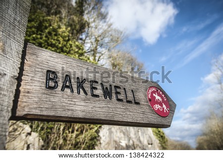 Wooden footpath sign for Bakewell on the Monsal Trail, Derbyshire. The trail is an old railway line closed in the 60's.