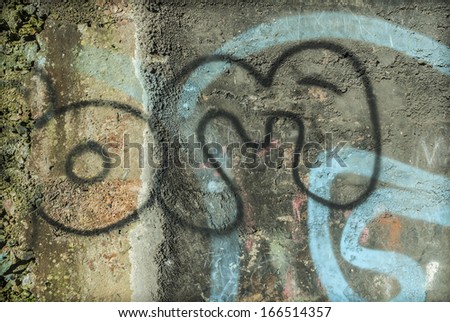Old concrete wall with graffiti making an abstract background.