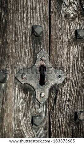 Old church key hole in oak door.