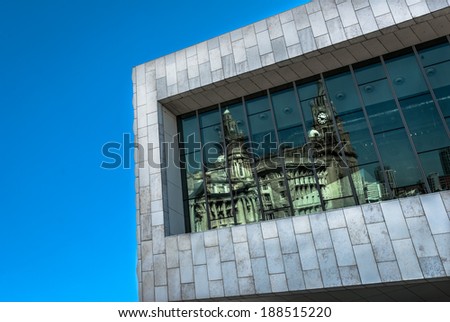 The window of the museum of Liverpool reflecting the Liver Buildings.